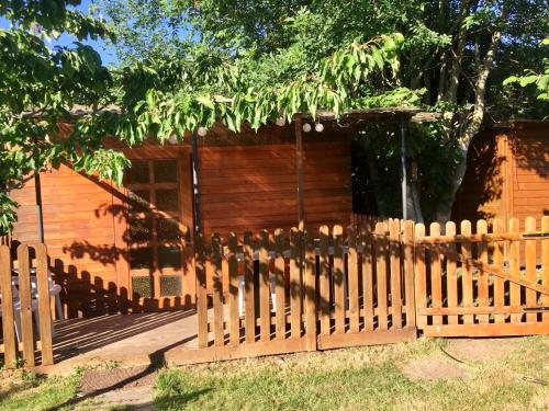 a wooden fence in front of a house at Yourte mongole in Huriel