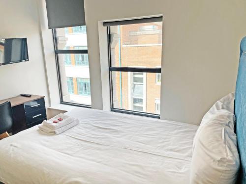 a bedroom with a bed and a window at Granite House Apartments in Liverpool