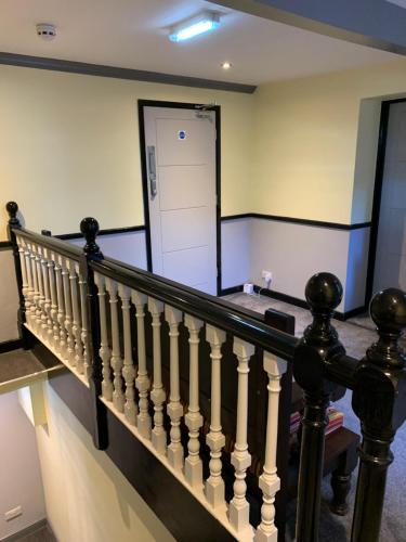 a hallway with a staircase with a white door at The Ivy in Lincolnshire