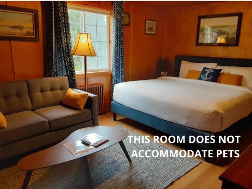 a hotel room with a bed and a couch at Anchor Inn Resort in Lincoln City