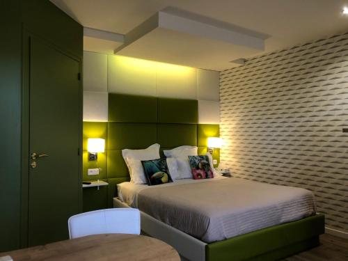 a bedroom with a large bed with green walls at chambre suite B&B in Montpellier