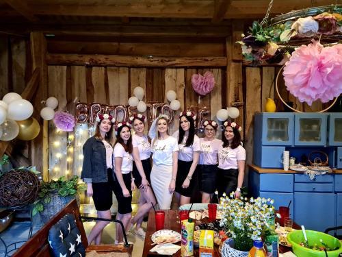 a group of girls posing for a picture in front of a table at Siedlisko Józefka in Zaróbka