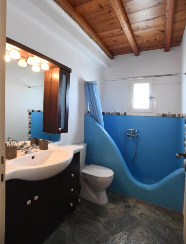 a bathroom with a blue sink and a toilet at Laurel house in Triandáros