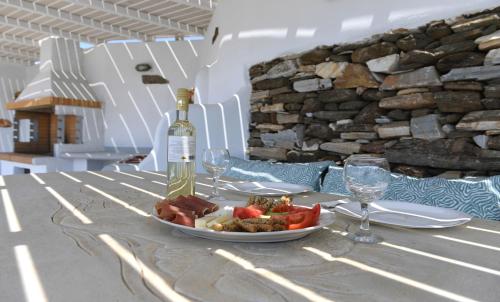 a plate of food and a bottle of wine on a table at Laurel house in Triandáros
