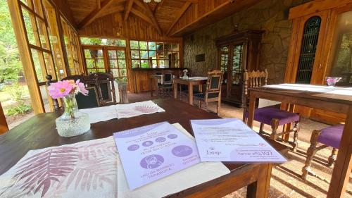 a table in a cabin with papers on it at Linaje Hotel Boutique & Relax in Lago Puelo