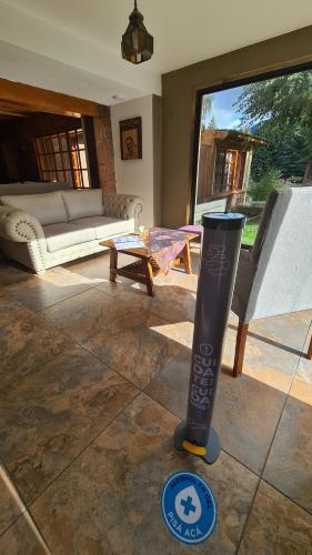 a living room with a couch and a vase on the floor at Linaje Hotel Boutique & Relax in Lago Puelo