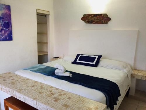 a bedroom with a bed with a stuffed animal on it at Villa Guitarron gran terraza vista espectacular 6 huespedes piscina gigante in Acapulco