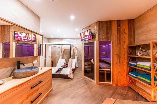 a bathroom with wooden walls and a sink and a mirror at Murtal Suiten in Zeltweg