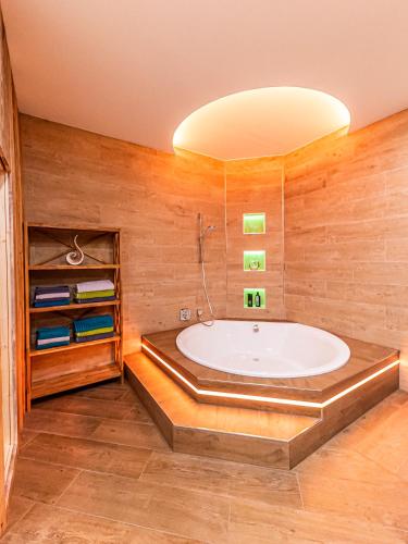 a large bathroom with a tub in a room at Murtal Suiten in Zeltweg