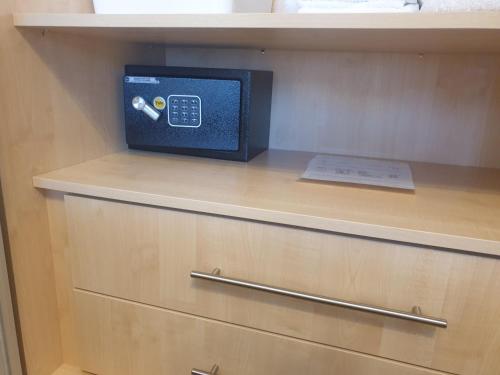 a cabinet with a television on top of it at London Luxury Apartments 5 min walk from Ilford Station, with FREE PARKING FREE WIFI in Ilford