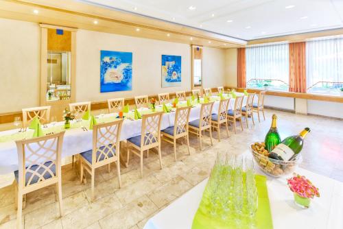 a conference room with a long table with chairs and wine bottles at Hotel Restaurant Kerzenstüble in Gärtringen