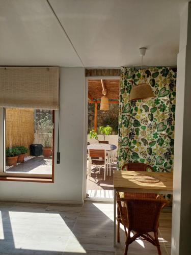 a kitchen with a table and a dining room at Apartamento Fontinha in Porto