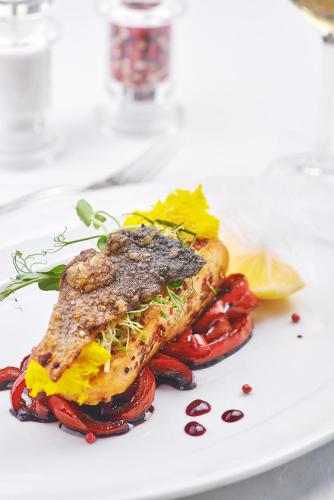 a white plate with a piece of food on it at GasthauS & SPA in Bukovel