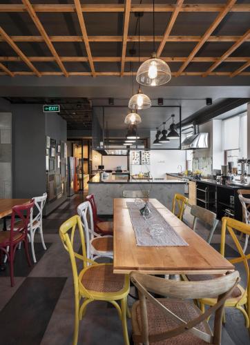 a dining room with a wooden table and chairs at Kantar Hotel in Yerevan