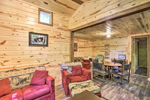 a log cabin living room with wooden walls at Loon Lake Lodge with Dock, Sauna and Hot Tub! in Pequot Lakes