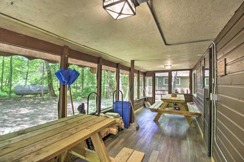 a room with benches and tables in a trailer at Loon Lake Lodge with Dock, Sauna and Hot Tub! in Pequot Lakes