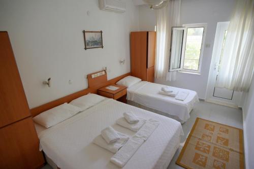 a room with two beds and a window at Patara Caretta Hotel in Patara