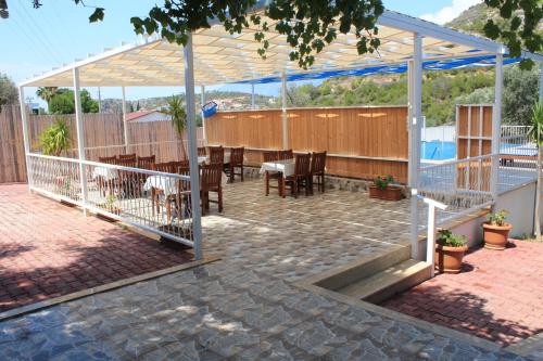 a patio with a table and chairs under a pavilion at Patara Caretta Hotel in Patara