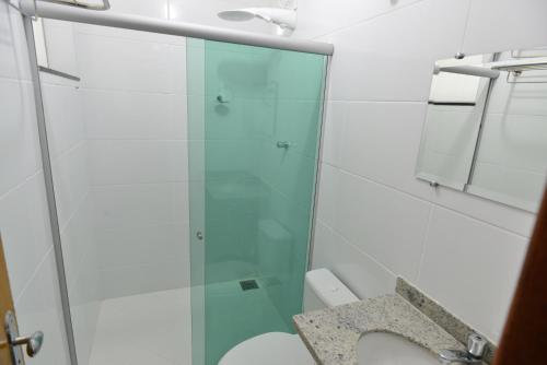 a bathroom with a glass shower and a toilet at Domus Hotel Cidade Nobre Ipatinga in Ipatinga