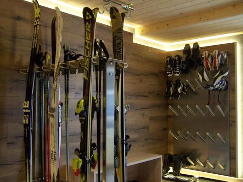 a room with skis and snowboards hanging on a wall at Landhaus Pichler in Tannheim