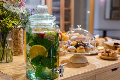 a glass jar filled with fruit and vegetables on a table at Hotel Margot House Barcelona in Barcelona