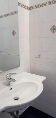 a bathroom with a white sink and a mirror at Sant'Ermete in Matino