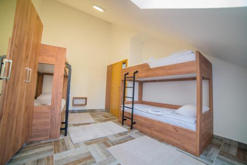 a room with two bunk beds and a doorway at Užički konak in Užice