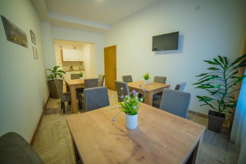 a dining room with tables and chairs and a television at Užički konak in Užice