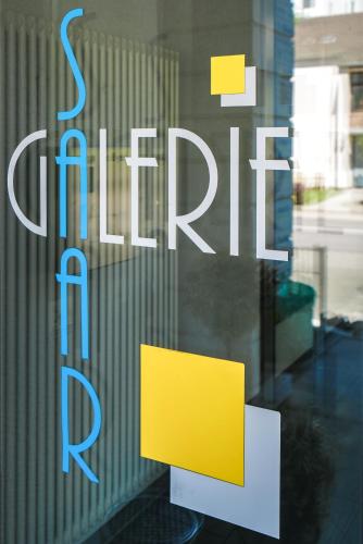 a sign on a window that says flirt at Saar Galerie in Saarburg