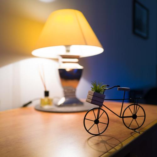 a small bike on a table with a lamp at Saar Galerie in Saarburg