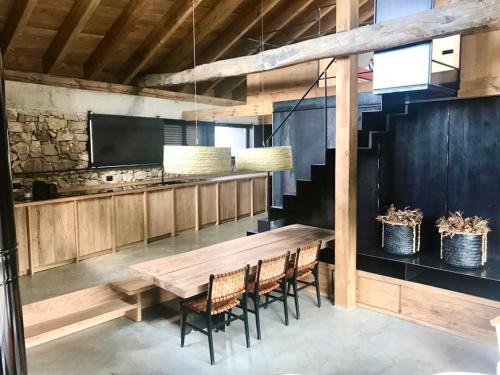 a dining room with a wooden table and chairs at El pajar de abajo - Pedraza - in La Alameda