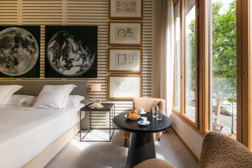 a bedroom with a bed and a table and chairs at Hotel Margot House Barcelona in Barcelona