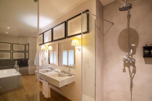 a bathroom with two sinks and a glass shower at Hotel Margot House Barcelona in Barcelona