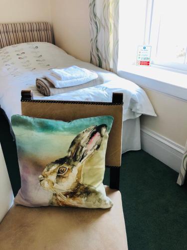 a box with a picture of a rabbit on it next to a bed at The Aberdeen Arms Hotel in Tarves