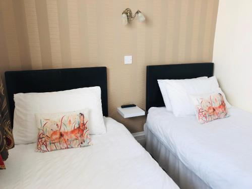 two beds sitting next to each other in a room at The Aberdeen Arms Hotel in Tarves