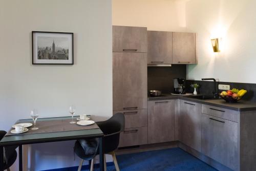 a kitchen with a table and a counter top at Saar Galerie in Saarburg