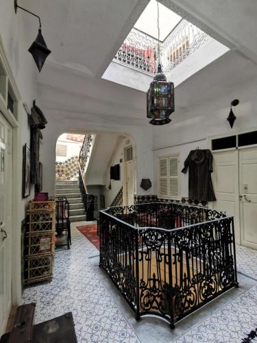 a room with a wrought iron crib in the middle of a room at Bayt Alice Hostel in Tangier