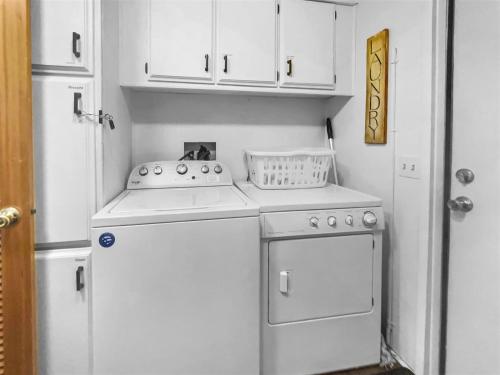 a small kitchen with a stove and a refrigerator at Bluegrass in Sisters