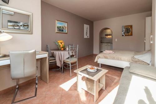 a living room with a bed and a table at Apartments Kari in Crikvenica