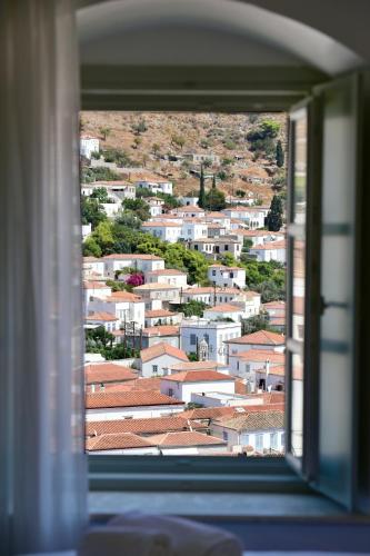 a view of a city from a window at Onar Hydra in Hydra