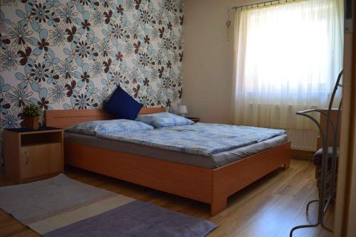 a bedroom with a bed in a room with a window at Apartment in Gyenesdias - Balaton 18809 in Gyenesdiás
