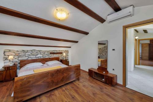 a bedroom with a large wooden bed in a room at Holiday home in Medulin/Istrien 9006 in Medulin