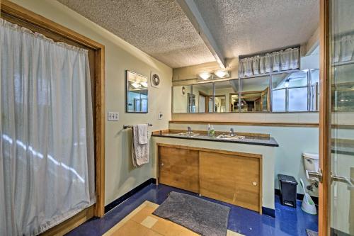 a bathroom with a sink and a large window at Riverfront Retreat about 4 Mi to Downtown Milwaukee! in Glendale