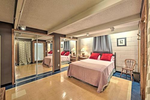 a bedroom with two beds and a mirror at Riverfront Retreat about 4 Mi to Downtown Milwaukee! in Glendale