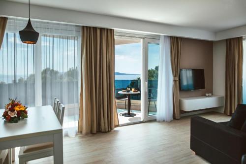 a living room with a view of the ocean at City Beach Makarska in Makarska