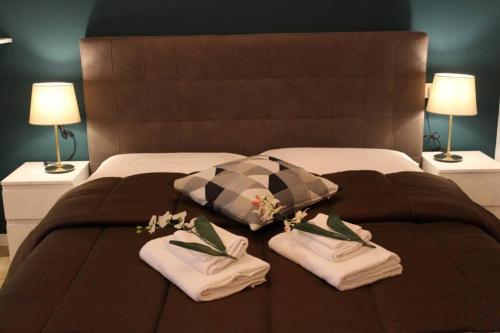 a bed with two towels and two pillows on it at Bologna Central Apartments - Indipendenza 43 in Bologna