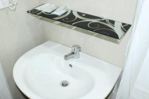 a bathroom with a white sink and a mirror at Bologna Central Apartments - Indipendenza 43 in Bologna