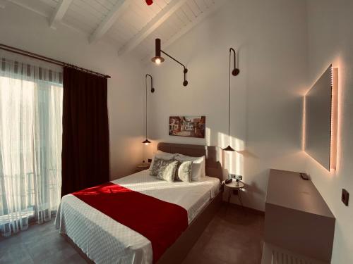 a bedroom with a bed with a desk and a window at Yerli Alaçatı in Alaçatı