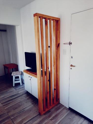 a room with a wooden door and a desk with a television at AP apartment Las Lomas in Martínez