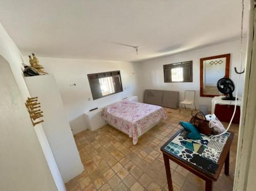 a bedroom with a bed and a table in a room at Casa de praia em Cotovelo in Parnamirim